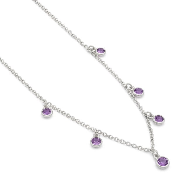 This graceful necklace showcases the timeless beauty of Amethyst gemstones, delicately arranged in a charming drop-style...