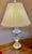 This lamp adds an elegant touch to various interior settings with its intricate patterns and warm gold toned base. The...