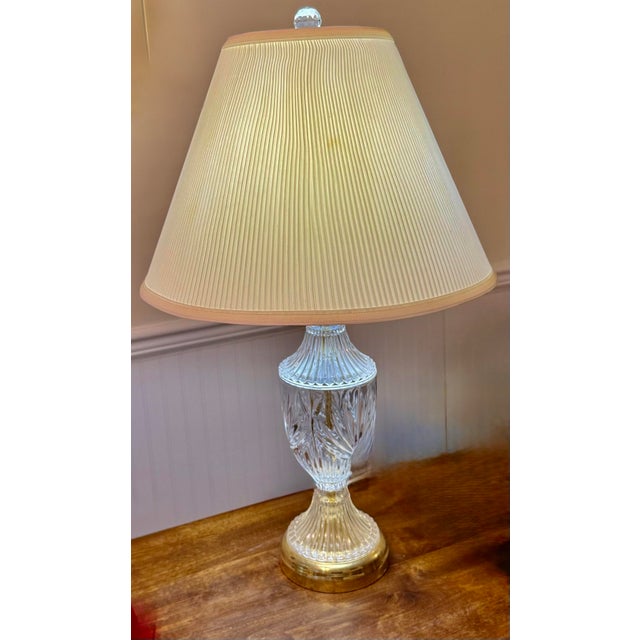 This lamp adds an elegant touch to various interior settings with its intricate patterns and warm gold toned base. The...