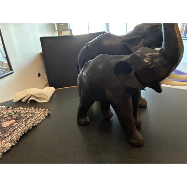 vintage pair of leather elephants two different sizes both in wonderful condition. great eyes and tusks. the smaller...