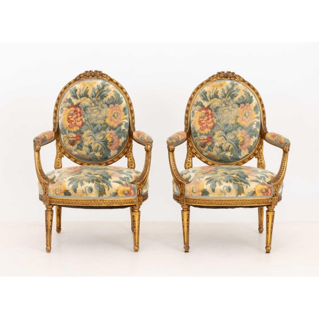 Pair of Louis XVI Style Tapestry Upholstered Giltwood Fauteuils, each with balloon back and ornately carved frame. 40.25"...
