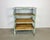 Industrial shelf from the 1960s. It features a green iron construction with iron mesh sides and back and four wooden shelves.