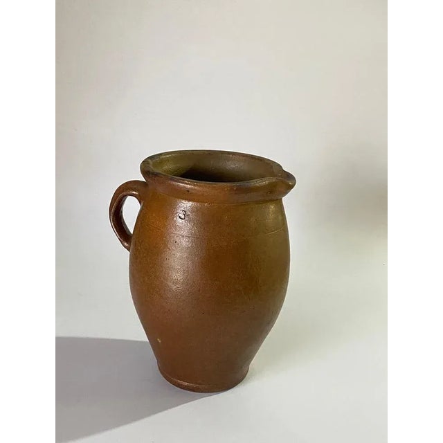 Jug or pitcher, with an exceptional patina. It's color with brown gives very pleasant contrasts. This Pitcher was created...