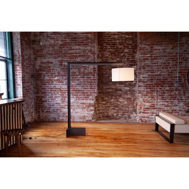 Luxurious custom ordered Christian Liaigre floor lamp in Oak with an Equestre finish and Epoxy Manganese metal. This...