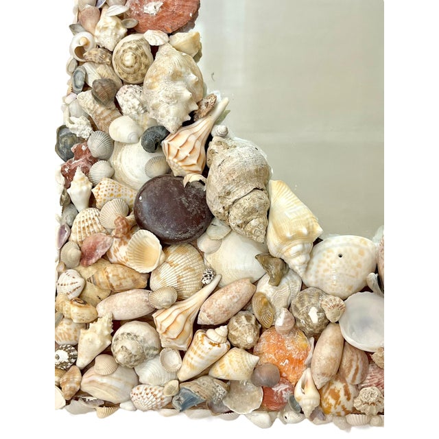 Vintage shell framed mirror. Lots of fun shells in all shapes, sizes and colors. Even a river rock or two. Shells all...