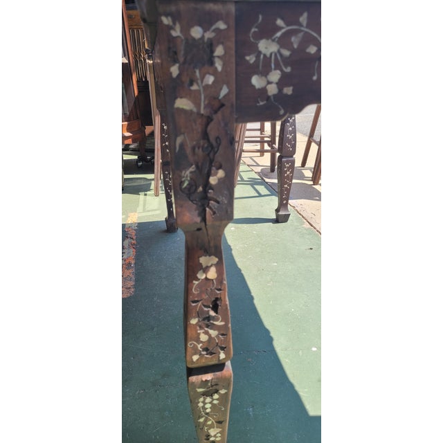 Rare 19th century inlaid Chinese table. Features very dense Hardwood inlaid with mother of pearl featuring Chinese...