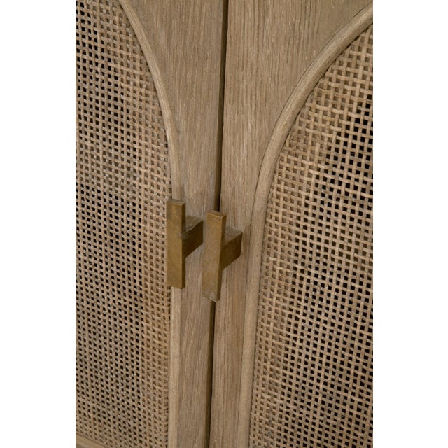 This is a bohemian-style media cabinet with rustic charm. It features muted smoke gray tones and a natural appearance....