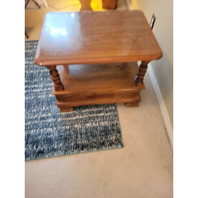 A warm, traditional side table crafted from solid hardwood, featuring a rectangular top, beautifully turned legs, and a...