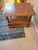 A warm, traditional side table crafted from solid hardwood, featuring a rectangular top, beautifully turned legs, and a...