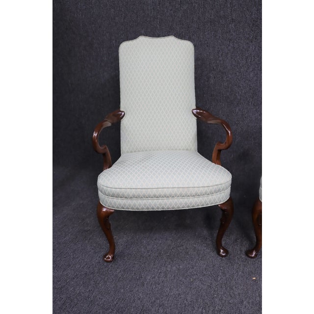 A pair of Queen Anne style lounge chairs , solid cherry frames with Shepard’s crook style arms, light green off white...