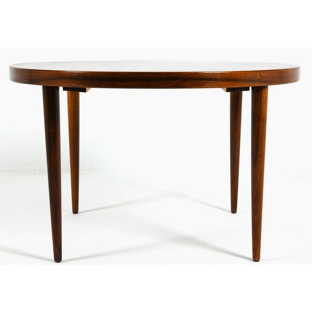 A Danish modern rosewood dining table. This table is a perfect size for a cozy dining space, be it adjacent to a kitchen,...