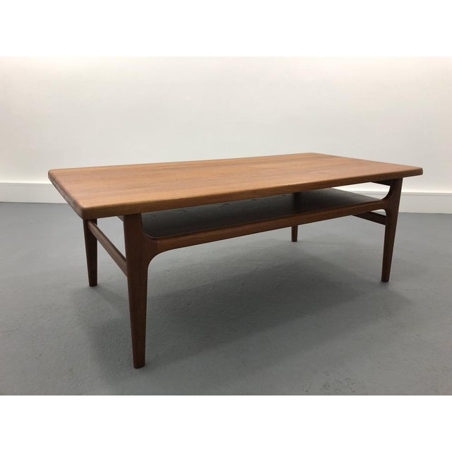 Rectangular solid teak coffee table designed by Niels Bach for Niels Bach Møbelfabrik in 1970s. Furniture in very good...