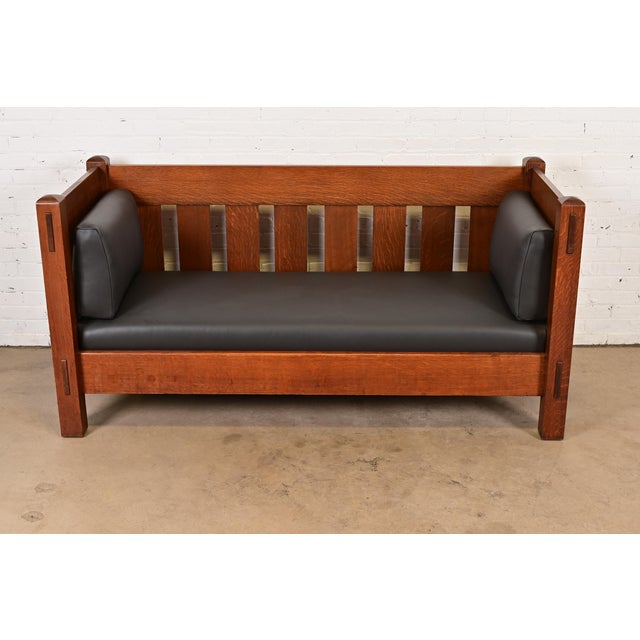 An exceptional antique Mission or Arts & Crafts settle sofa or loveseat By Charles P. Limbert Co. USA, Circa 1910 Solid...