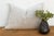 Two stacked diamond medallions rest side by side at the center of this handcrafted Moroccan cactus silk lumbar pillow,...