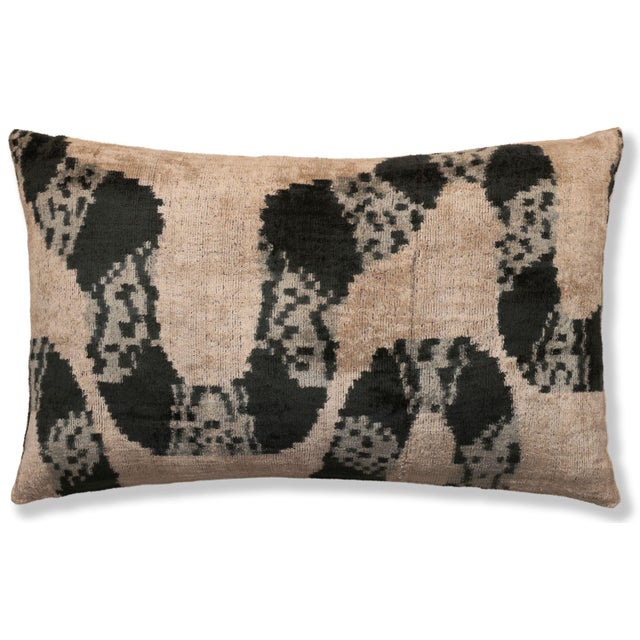 "This luxury silk velvet ikat lumbar pillow features a refined black pattern layered over a warm natural base, creating a...