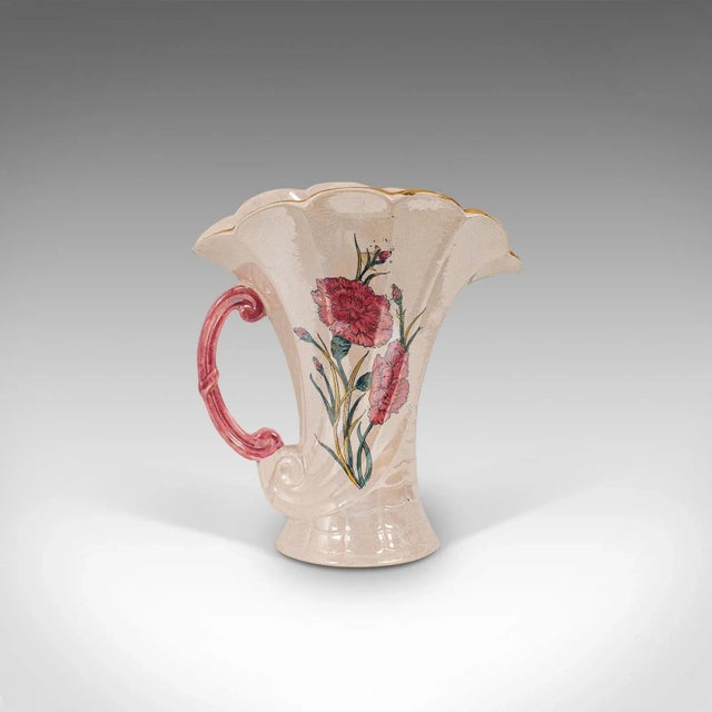 This is a vintage decorative pouring jug. An English, ceramic breakfast milk pot in Carnation pattern, dating to the...