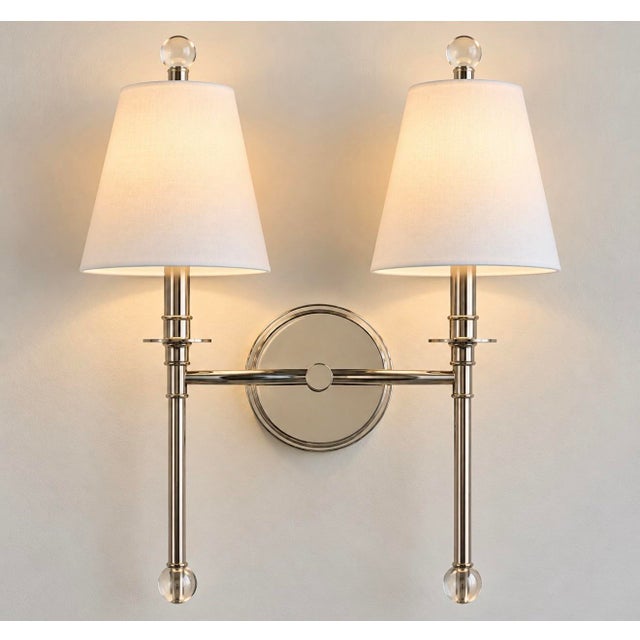 Notably polished and elegant take on the traditional candle sconce. Featuring two gracefully balanced arms, this double...