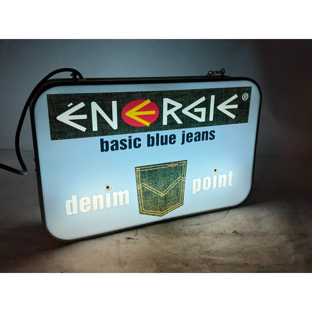 Beautiful shop sign for the Italian clothing brand Energie, an iconic symbol of 1980s and 1990s fashion. It's a...