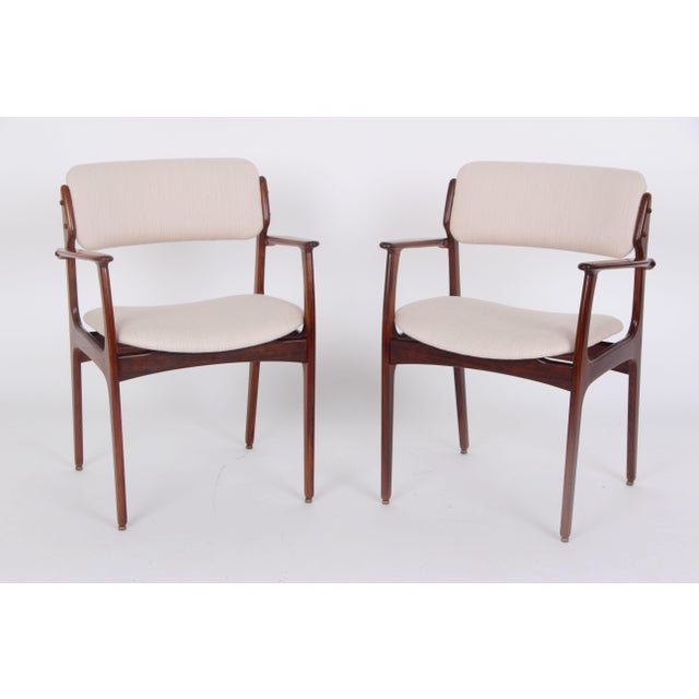 Two rosewood chairs, model OD50. Designed by Erik Buch for Oddense Møbelfabrik. The chairs have a unique look and are very...