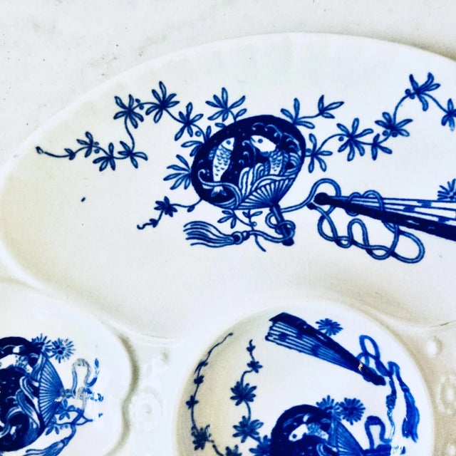 19th century porcelain flow blue oyster plate decorated with fans inspired by the Japonisme, circa 1891. Bombay pattern....