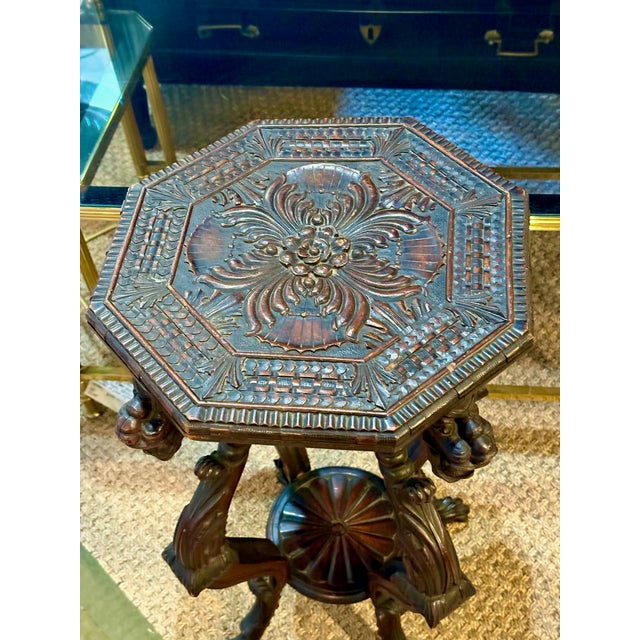 This is a charming highly carved small table or stand that features fantastical dragons as leg supports. The table has a...