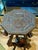 This is a charming highly carved small table or stand that features fantastical dragons as leg supports. The table has a...