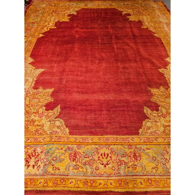 Presenting a late 19th century Turkish Oushak room size rug hand-woven in Anatolia region during the late 1800s featuring...