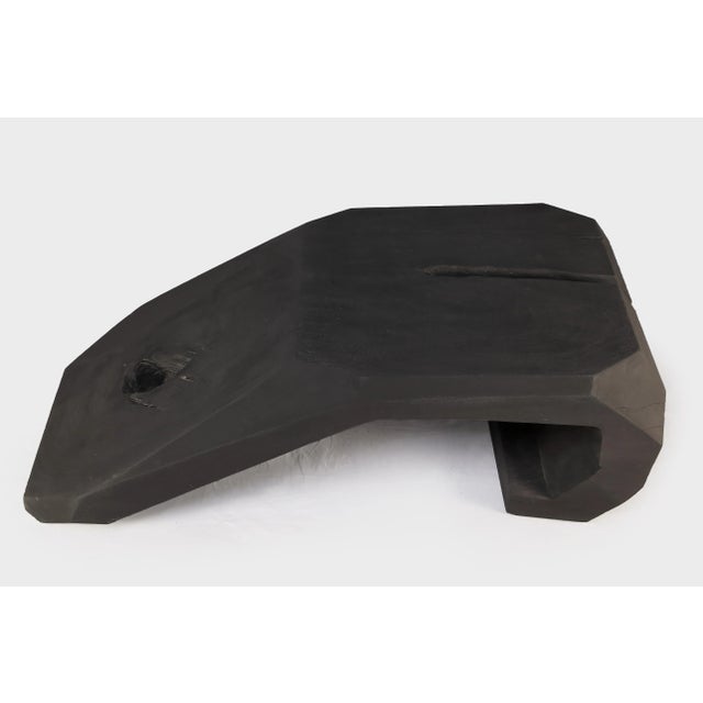 This black coffee table is hand carved out one single piece of wood. Modern water fall form with its natural wood...