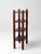 An early 20th century wood etagere with a narrow, upright profile and a quiet, structured presence. Four open shelves are...