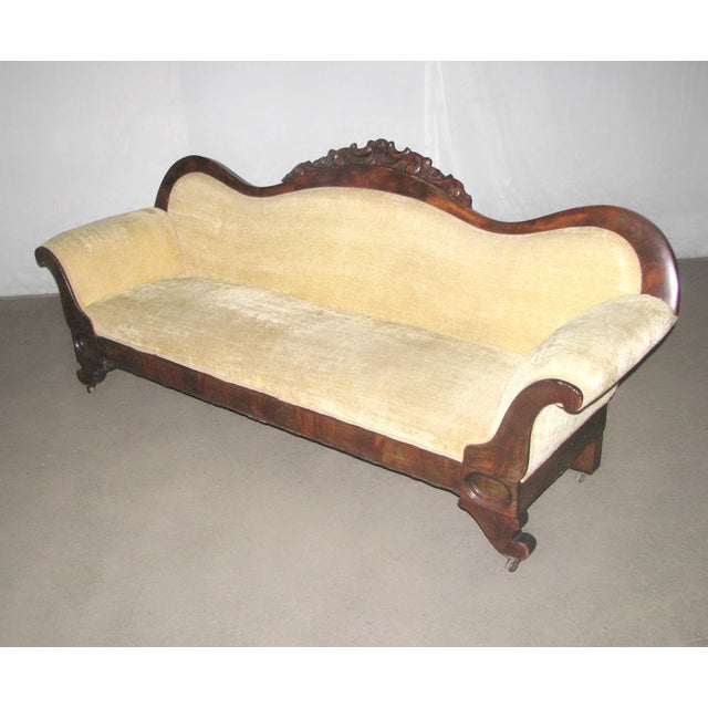 Victorian parlor settee styled sofa in solid walnut. This piece captures the Victorian dramatic form with sweeping crest...