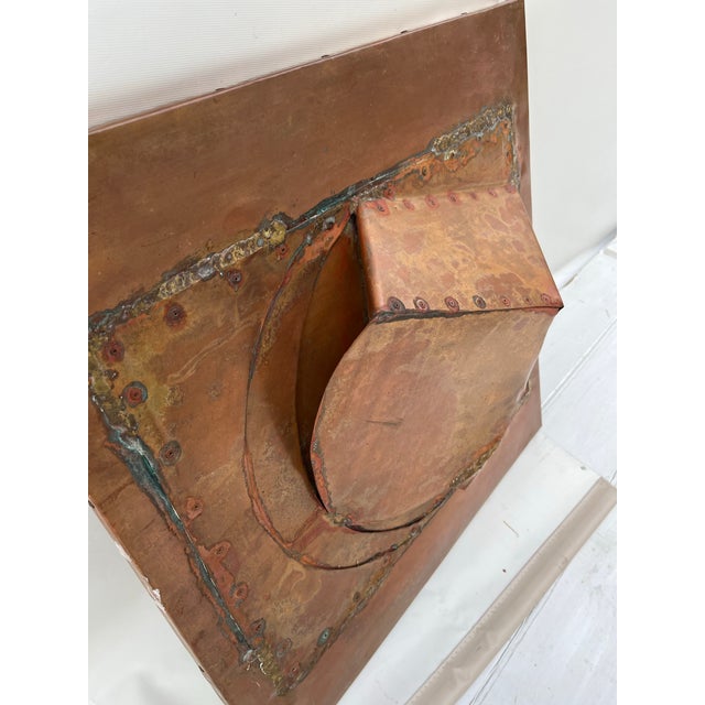 A single 24” square copper metal dimensional wall sculpture.