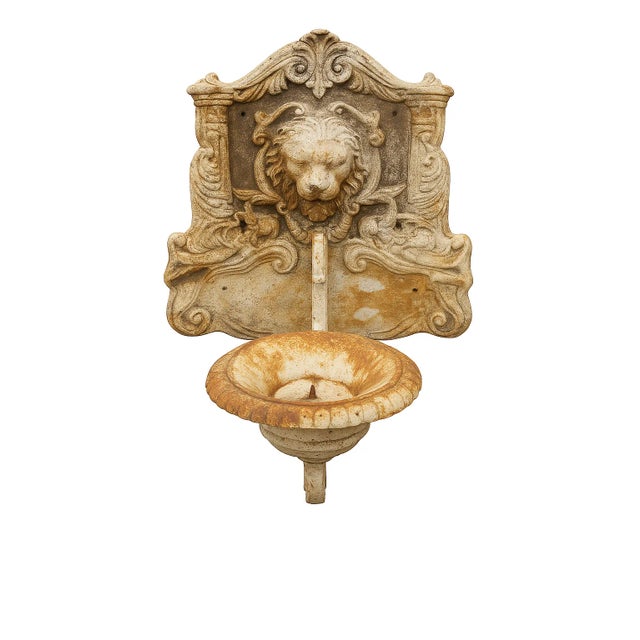 Monumental 19th-century cast-iron architectural salvage wall bracket featuring a roaring lion mask with elaborate scroll-...