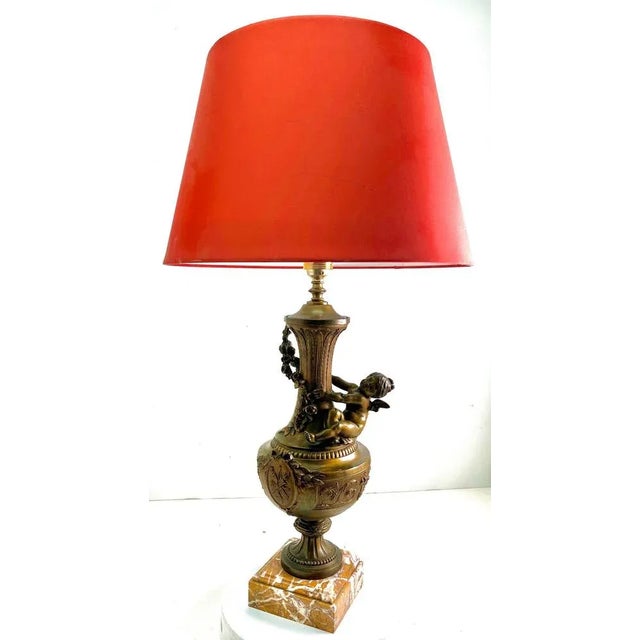 Pair of ornamented vases or lamps with little angels and richly decorated on Marble Base. As Service we can also make...