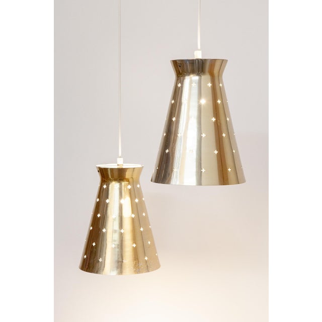These perforated ceiling lights made of brass-plated aluminum were manufactured by the German company Hillebrand in the...