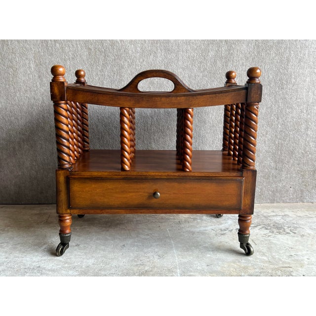 Vintage English Canterbury wood magazine rack on metal casters. This is a beautiful, high quality, magazine rack that...