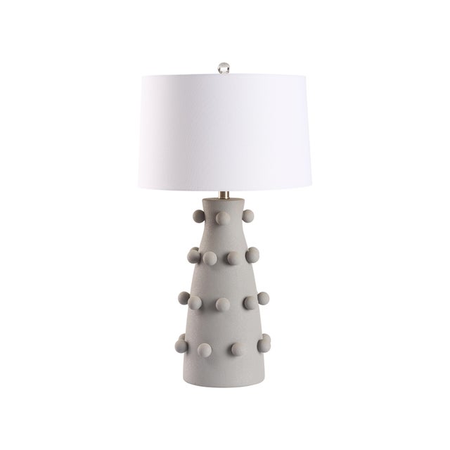 This gray ceramic lamp features a textured finish adorned with decorative balls, adding visual interest. Its modern yet...