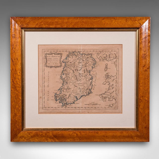 This is an antique map of Ireland. A French, maple framed cartography engraving by Jean-Baptiste Nolin, this posthumous...