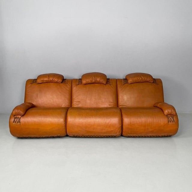 Italian modern modular brown leather sofa, 1970s Composed of three sections, upholstered in cognac color leather and...