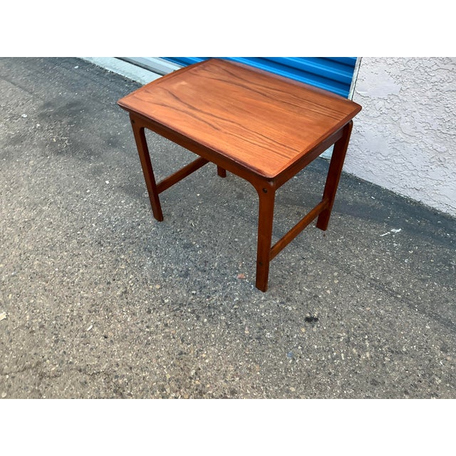 A finely crafted Scandinavian Modern occasional table or end table in highly figured warm toned teak. Finely honed curved...