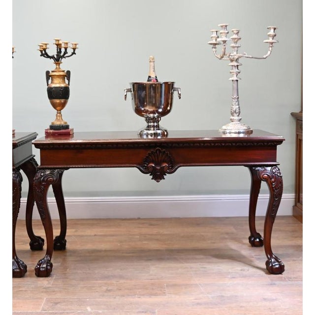 An impressive pair of Chippendale Revival mahogany console tables dating to circa 1890 Each features a rectangular top...