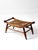 This vintage Early American rush seat bench features a woven natural fiber seat set within a warm wood frame with turned...
