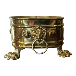 Early 20th Century English Edwardian Brass Cachepot Jardiniere Planter With Lion Mask Ring Handles and Raised on Animal Paw Feet
