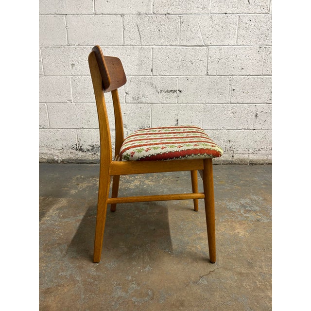 Set of 4 original Danish teak & oak dining chairs. Original upholstery and typical Danish design with oak and teak frames.