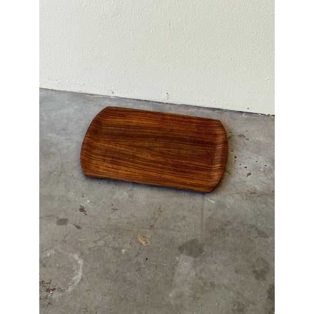 Elegant mid-century Danish serving tray crafted from richly figured rosewood. The tray features beautifully sculpted,...