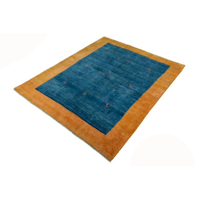 This beautiful Gabbeh nomad rug was carefully hand-knotted and embodies the simple beauty of traditional nomad art. The...