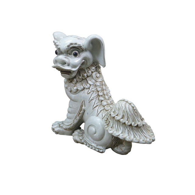 A large and impressive pair of blanc de chine porcelain Chinese guardian lions / Foo Dogs / Shishi. Made from high-quality...