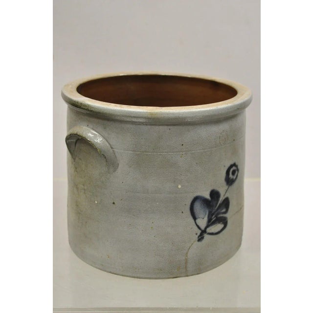 Antique Stoneware Salt Glazed 9" Round Pottery Crock Pot with Blue Flower. Circa 19th Century. Measurements: 8" H x 9"...