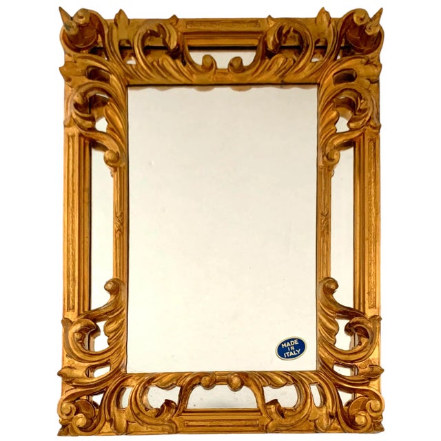 Stunning Italian vintage wall mirror with gilded gold-leaf Rococo frame. Jewel-like accent for entryways and powder rooms....