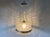 This pendant lamp is from Germany from the 1970s. It is made of glass, metal and plastic parts. The glass ball is held by...