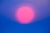 This photographic work captures a surreal sunset, where a vibrant pink sun emerges against a soothing gradient of blue...